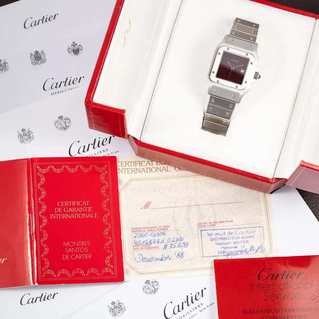 A Cartier Santos Carrée with a burgundy dial, with its box and papers