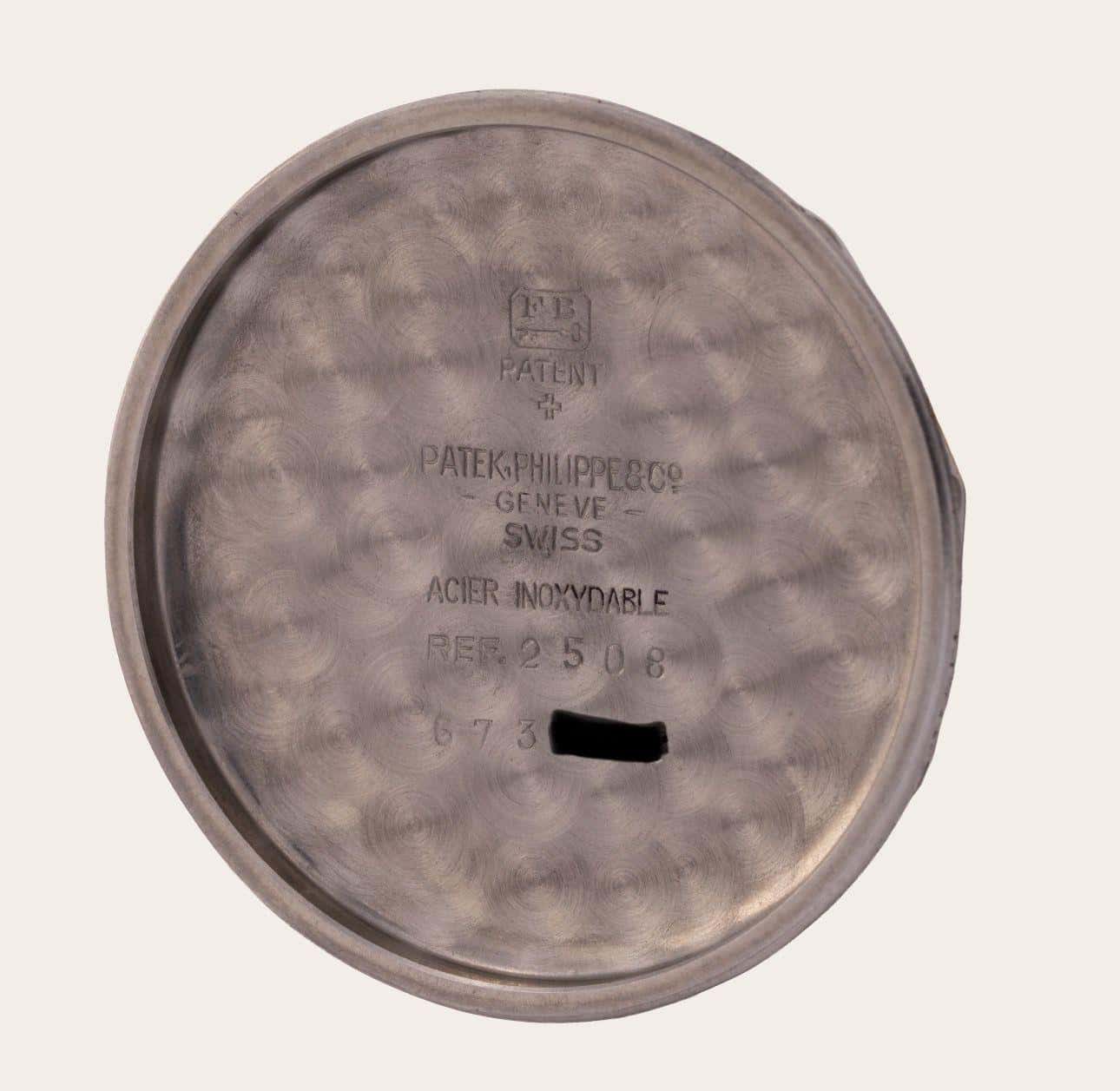 The inside of a case-back, stamped with the reference and the metal